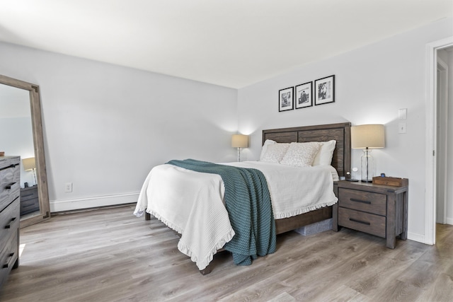48 Garfield St Unit 7, Saco, ME 04072 - bedroom with wood finished floors and baseboard heating