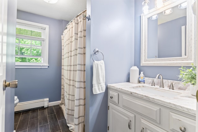 48 Garfield St Unit 7, Saco, ME 04072 - bathroom featuring a baseboard heating unit, vanity, wood finish floors, and a shower with shower curtain