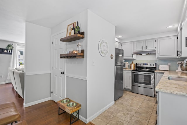 48 Garfield St Unit 7, Saco, ME 04072 - kitchen with stainless steel electric range oven, refrigerator with ice dispenser, recessed lighting, under cabinet range hood, and a baseboard radiator