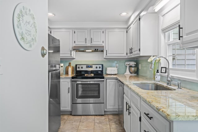 48 Garfield St Unit 7, Saco, ME 04072 - kitchen featuring appliances with stainless steel finishes, under cabinet range hood, recessed lighting, light stone countertops, and tasteful backsplash