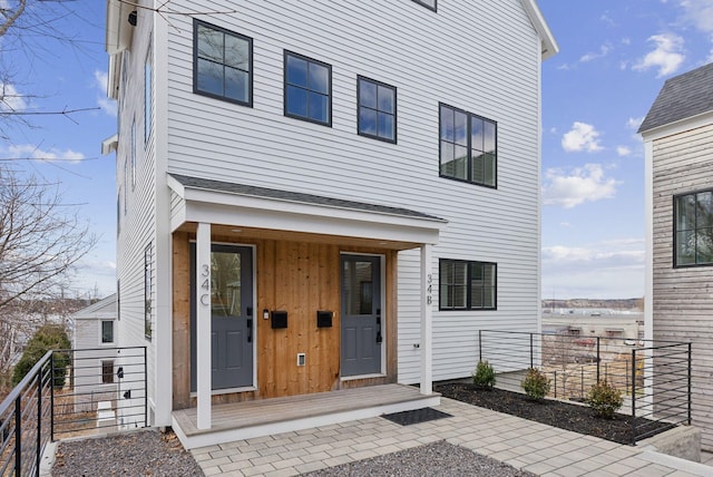 34 Hammond St Unit B, Portland, ME 04101 - view of front of property featuring covered porch and board and batten siding