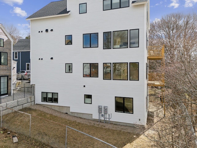 34 Hammond St Unit B, Portland, ME 04101 - view of property exterior featuring a shingled roof and fence private yard
