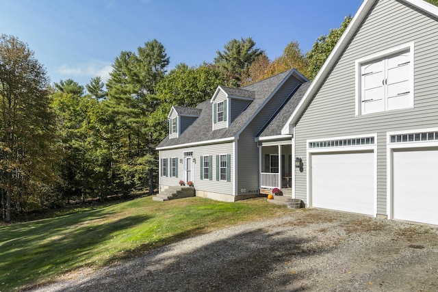 cape cod home featuring a shingled roof, entry steps, an attached garage, a front lawn, and driveway