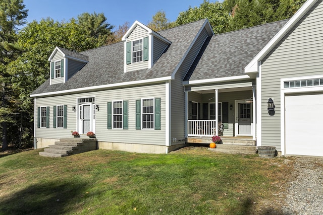 cape cod-style house with roof with shingles, a garage, a front yard, and covered porch