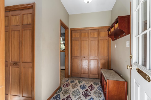doorway to outside featuring a baseboard radiator and baseboards