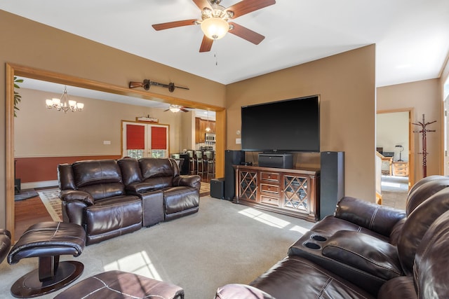 carpeted living room featuring ceiling fan with notable chandelier