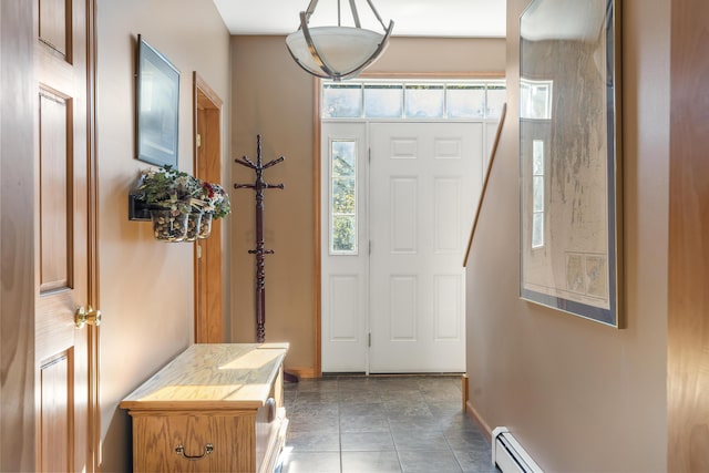 foyer featuring baseboard heating and baseboards