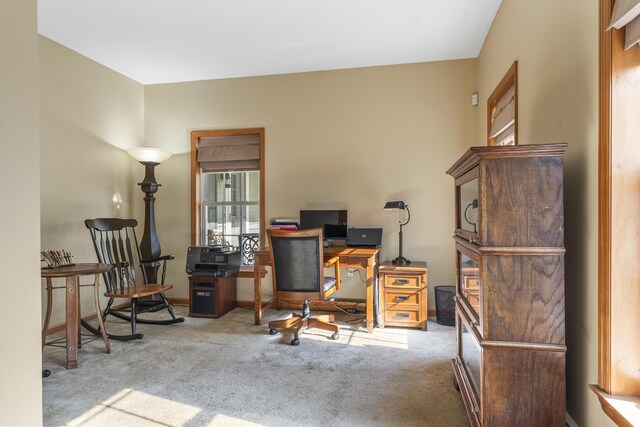carpeted office space featuring baseboards