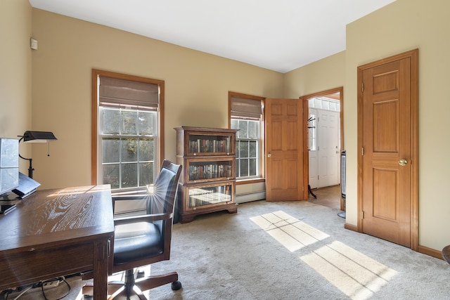 carpeted home office featuring a baseboard heating unit