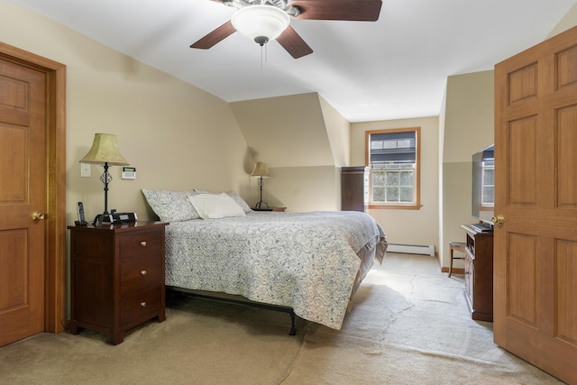 bedroom with a ceiling fan, light colored carpet, and a baseboard heating unit