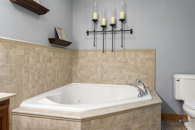 bathroom featuring toilet, vanity, and a garden tub