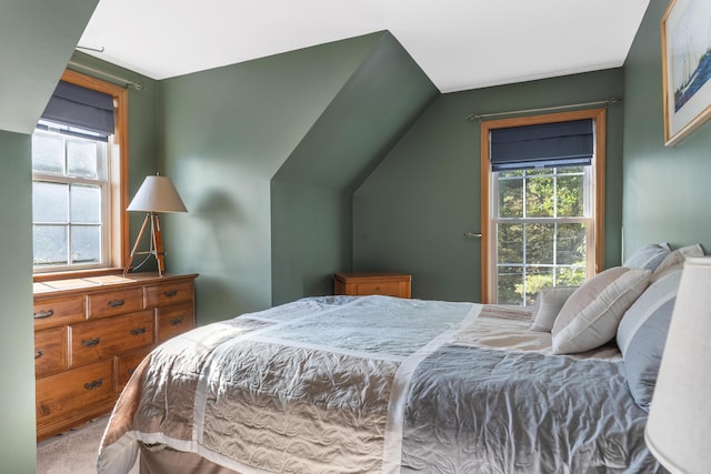 carpeted bedroom with lofted ceiling