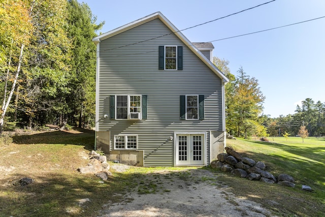 rear view of property featuring french doors and a yard