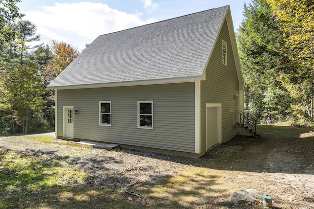 back of property featuring roof with shingles and entry steps