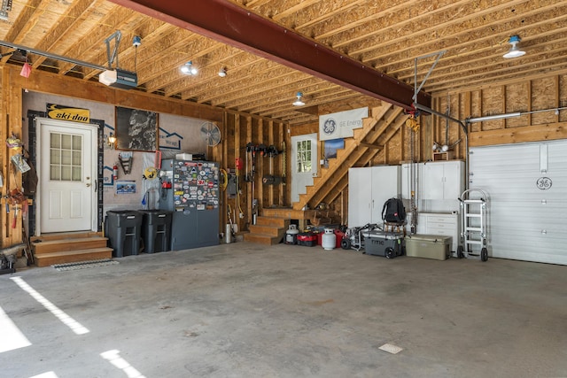 garage featuring fridge and a garage door opener