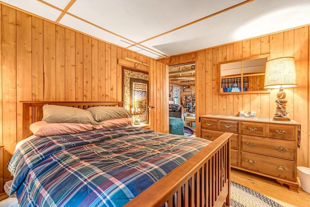 32 Seymour Cove Rd, Bowerbank, ME 04426 - bedroom with wooden walls and light wood-type flooring
