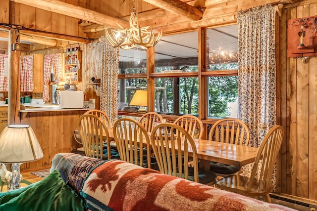 32 Seymour Cove Rd, Bowerbank, ME 04426 - dining area featuring a chandelier, wood walls, and beamed ceiling