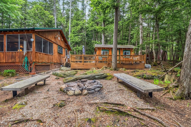 32 Seymour Cove Rd, Bowerbank, ME 04426 - back of house featuring a sunroom, a wooden deck, and a view of trees