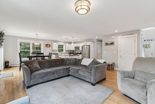 33 Old Dynamite Way, Gorham, ME 04038 - living room with light wood-style flooring, recessed lighting, a baseboard radiator, a chandelier, and baseboards