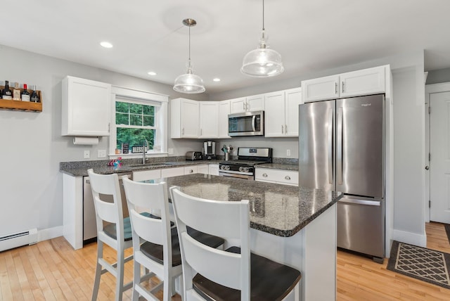 33 Old Dynamite Way, Gorham, ME 04038 - kitchen with stainless steel appliances, a sink, light wood-type flooring, baseboard heating, and white cabinetry