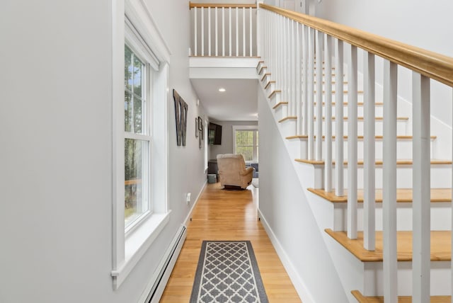 33 Old Dynamite Way, Gorham, ME 04038 - hall featuring light wood-style flooring, stairway, baseboards, and a baseboard radiator