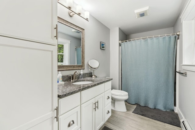 33 Old Dynamite Way, Gorham, ME 04038 - bathroom with a baseboard heating unit, toilet, vanity, wood finished floors, and curtained shower