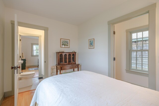 421 Petitmanan Point Rd, Steuben, ME 04680 - bedroom featuring multiple windows and wood finished floors