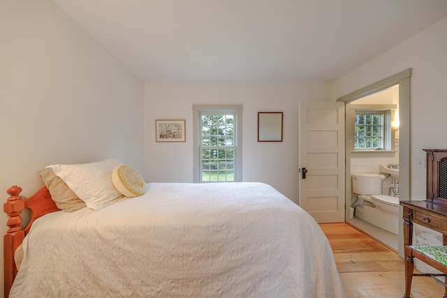 421 Petitmanan Point Rd, Steuben, ME 04680 - bedroom featuring light wood-type flooring and multiple windows
