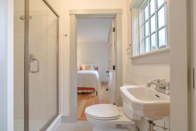 421 Petitmanan Point Rd, Steuben, ME 04680 - ensuite bathroom featuring a shower stall, toilet, and wood finished floors