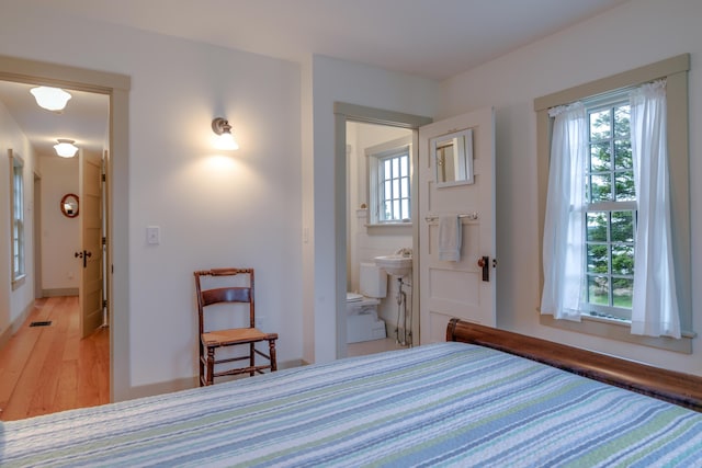 421 Petitmanan Point Rd, Steuben, ME 04680 - bedroom with light wood-style flooring, a sink, and baseboards