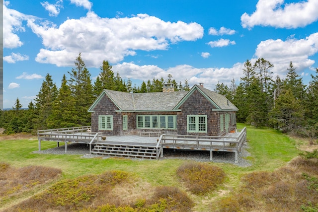 421 Petitmanan Point Rd, Steuben, ME 04680 - back of property with a chimney, a wooden deck, a yard, and a shingled roof