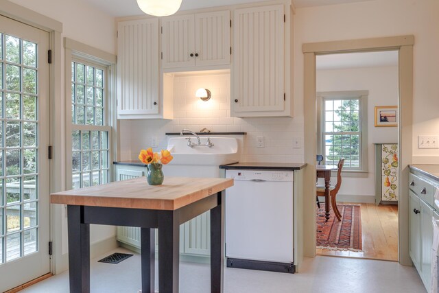421 Petitmanan Point Rd, Steuben, ME 04680 - kitchen featuring dishwasher, decorative backsplash, healthy amount of natural light, and a sink