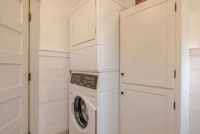 421 Petitmanan Point Rd, Steuben, ME 04680 - laundry room with stacked washer / dryer and cabinet space