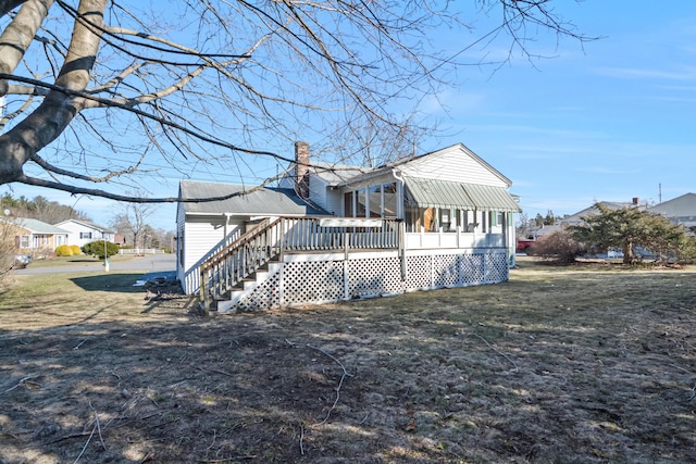 58 Bayview Ter, Wells, ME 04090 - rear view of property featuring a lawn, a chimney, a sunroom, and a wooden deck