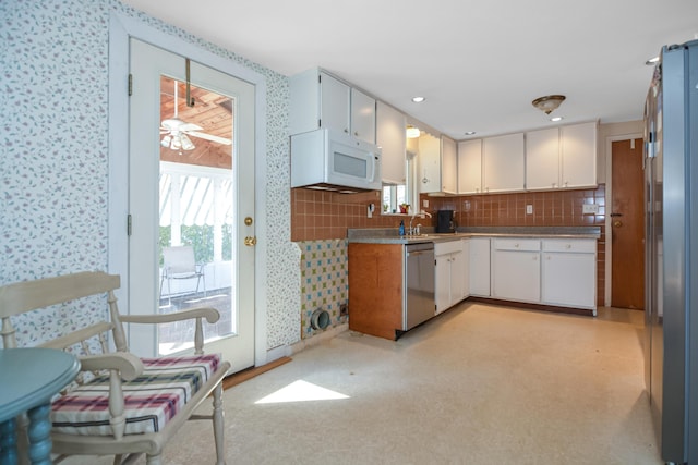 58 Bayview Ter, Wells, ME 04090 - kitchen with a ceiling fan, tasteful backsplash, light floors, stainless steel appliances, and wallpapered walls