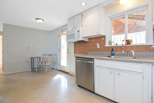 58 Bayview Ter, Wells, ME 04090 - kitchen featuring white cabinetry, wallpapered walls, a sink, dishwasher, and white microwave