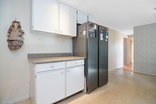 58 Bayview Ter, Wells, ME 04090 - kitchen featuring white cabinetry, wallpapered walls, and baseboards