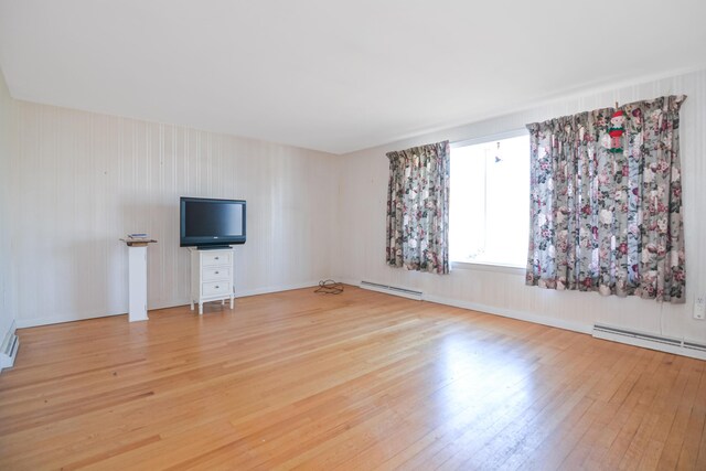 58 Bayview Ter, Wells, ME 04090 - unfurnished living room with a baseboard radiator and light wood-type flooring