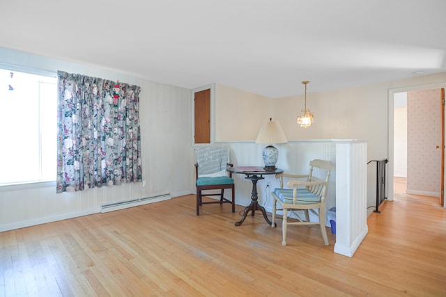 58 Bayview Ter, Wells, ME 04090 - sitting room with a baseboard radiator, an inviting chandelier, hardwood / wood-style flooring, and baseboards