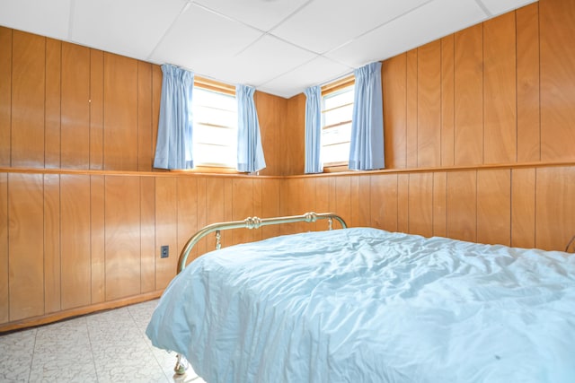 58 Bayview Ter, Wells, ME 04090 - bedroom with tile patterned floors, wooden walls, and a paneled ceiling