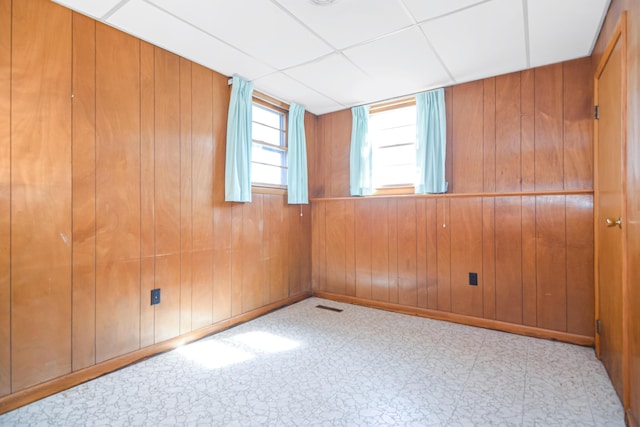 58 Bayview Ter, Wells, ME 04090 - empty room with tile patterned floors, visible vents, wood walls, and a drop ceiling