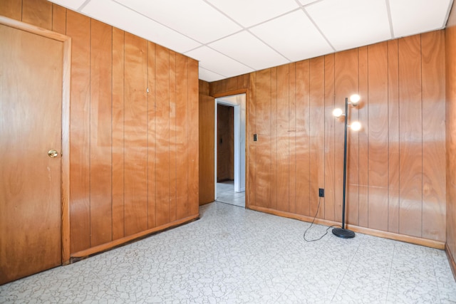 58 Bayview Ter, Wells, ME 04090 - unfurnished bedroom with tile patterned floors, wooden walls, and a paneled ceiling