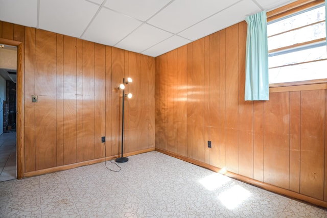 58 Bayview Ter, Wells, ME 04090 - unfurnished bedroom featuring wood walls, tile patterned floors, and a paneled ceiling