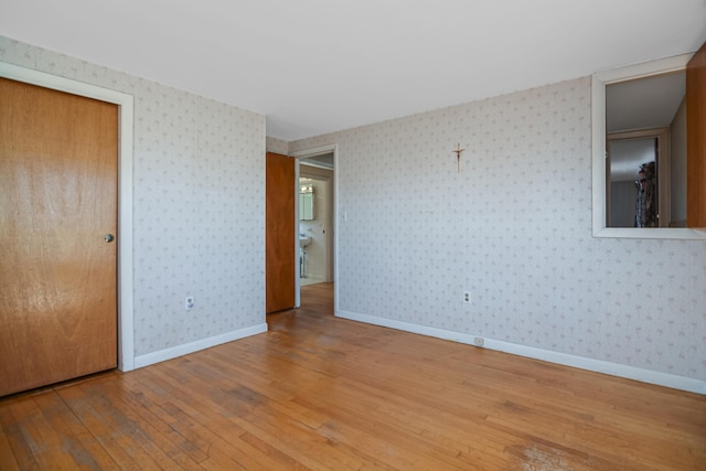 58 Bayview Ter, Wells, ME 04090 - unfurnished room featuring wood-type flooring, wallpapered walls, and baseboards