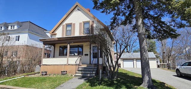 23 Brook St, Waterville, ME 04901 - view of front of home featuring a front yard, a porch, an outdoor structure, and a detached garage