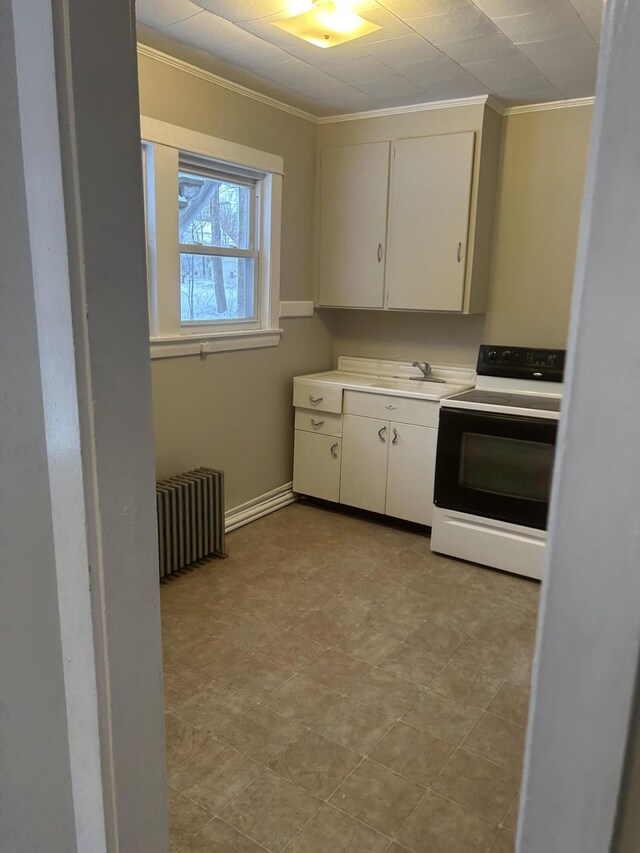 kitchen with white cabinetry, light countertops, crown molding, electric stove, and radiator heating unit
