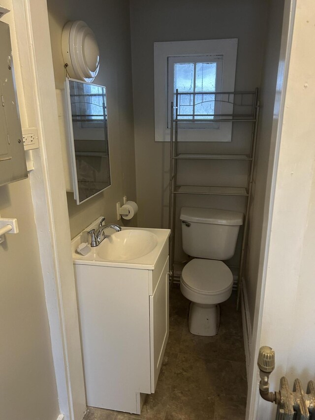 half bathroom featuring toilet and vanity