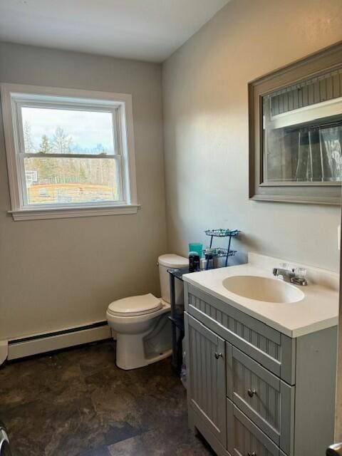 half bath with a baseboard radiator, toilet, and vanity
