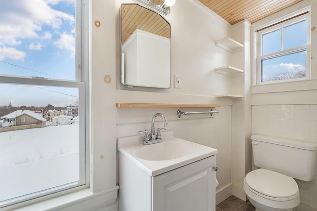 57 Oxford St, Augusta, ME 04330 - half bath featuring vanity, wooden ceiling, toilet, and tile walls
