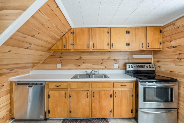 57 Oxford St, Augusta, ME 04330 - kitchen featuring appliances with stainless steel finishes, a sink, light countertops, wood walls, and brown cabinetry